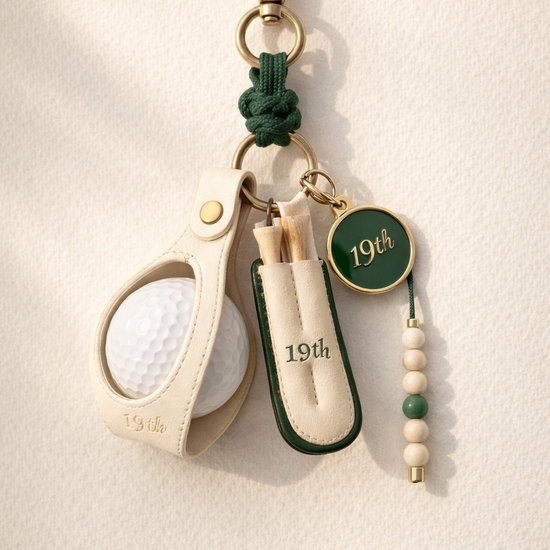 Nineteenth Society Lucky Charm bag charm in cream leather and Heritage Green on ecru canvas bag
