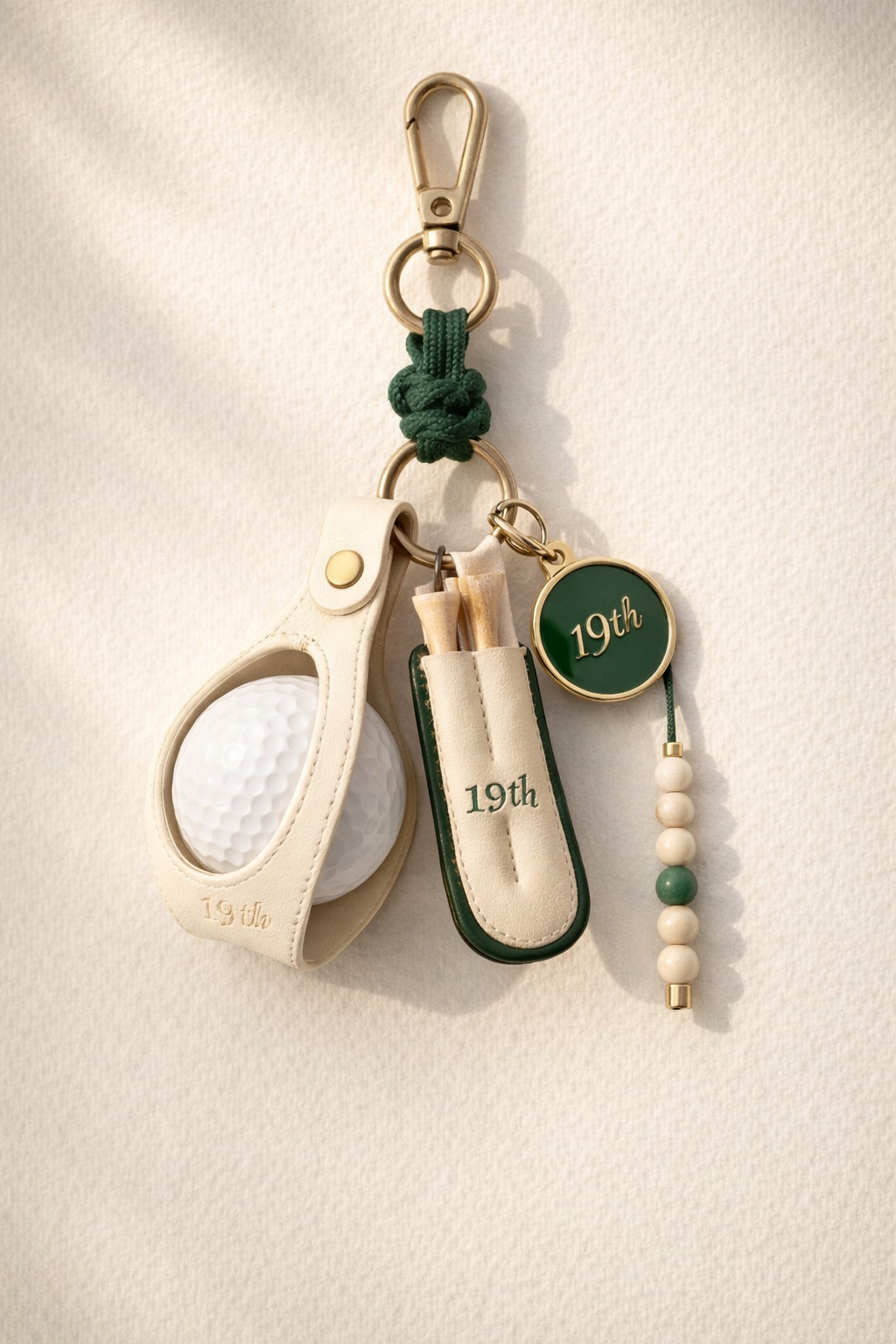 Nineteenth Society Lucky Charm bag charm in cream leather and Heritage Green on ecru canvas bag
