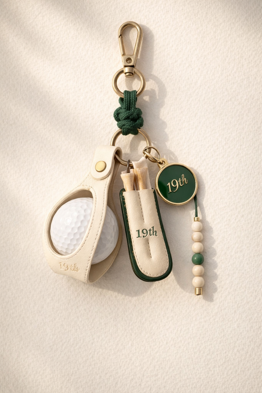 Nineteenth Society Lucky Charm bag charm in cream leather and Heritage Green on ecru canvas bag
