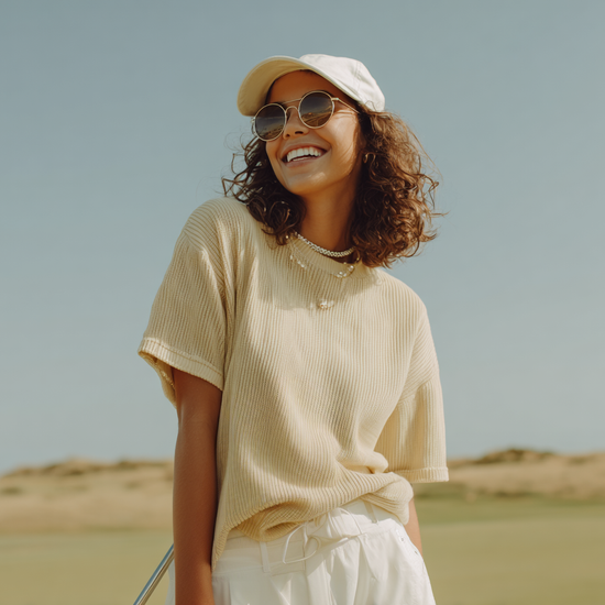 The Hat in ecru worn on golf course — womens golf hat lifestyle shot | Nineteenth Society