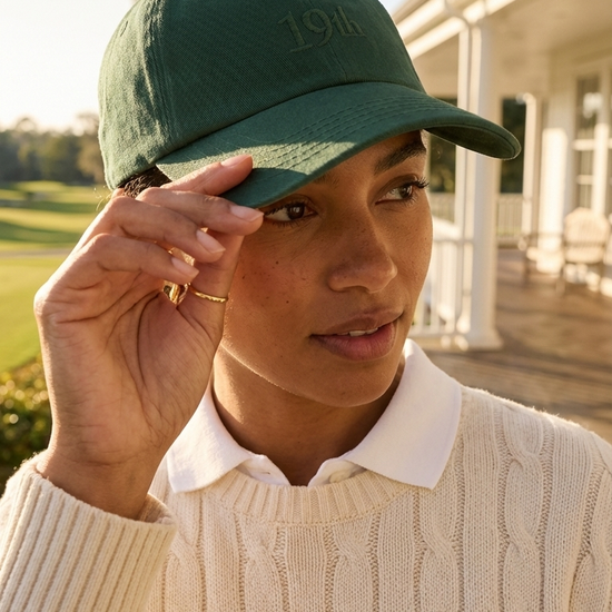 The Hat in heritage green worn at golf clubhouse — womens golf hat lifestyle | Nineteenth Society
