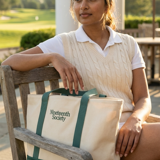 The Round Bag carried by woman at golf course — womens golf lifestyle bag | Nineteenth Society