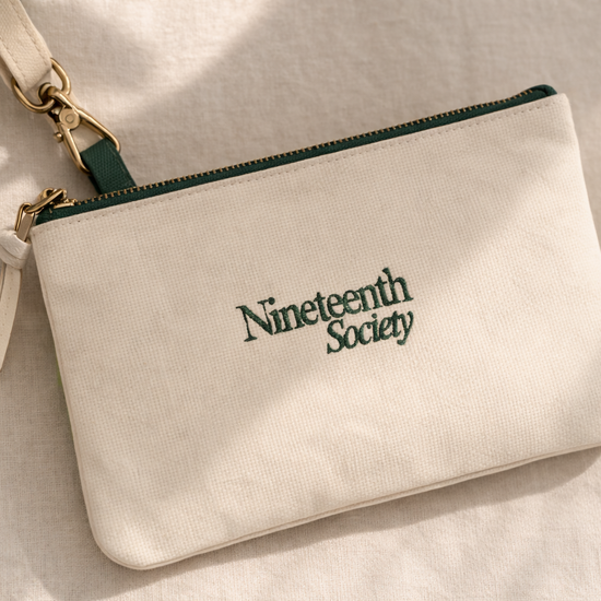 Nineteenth Society branded pouch in ecru canvas with forest green zip — golf accessory | Nineteenth Society